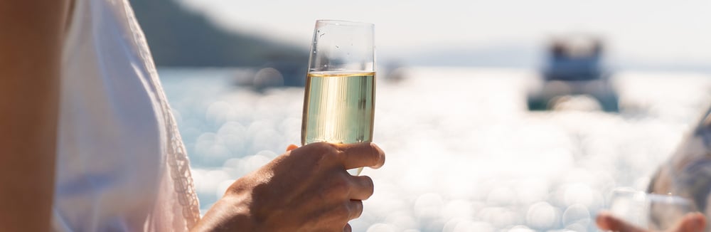 Woman-holding-champange-on-yacht-cruise-Best-All-Inclusive-Cruise-Lines