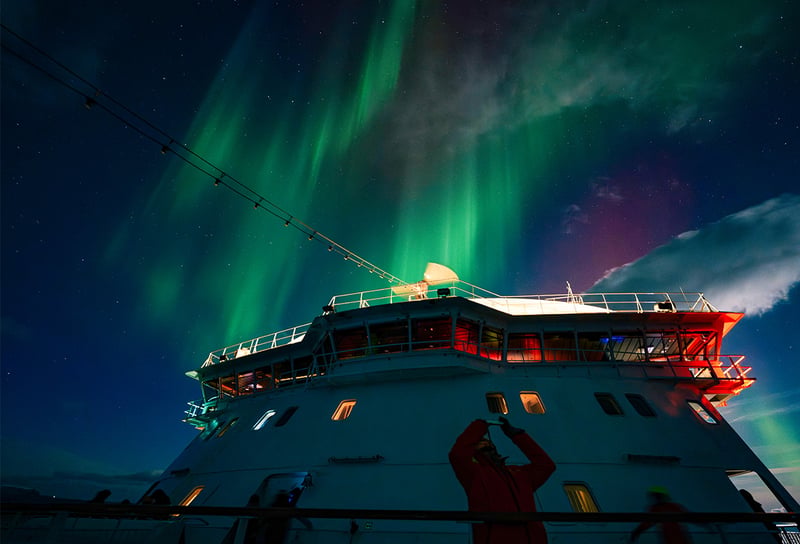 Northern lights seen from out on deck of Hurtigruten shi at the coast of Alta, Norway, photo taken by Kay Fochtmann - Northern Lights Cruises 2026 When, Where and How to See the Aurora
