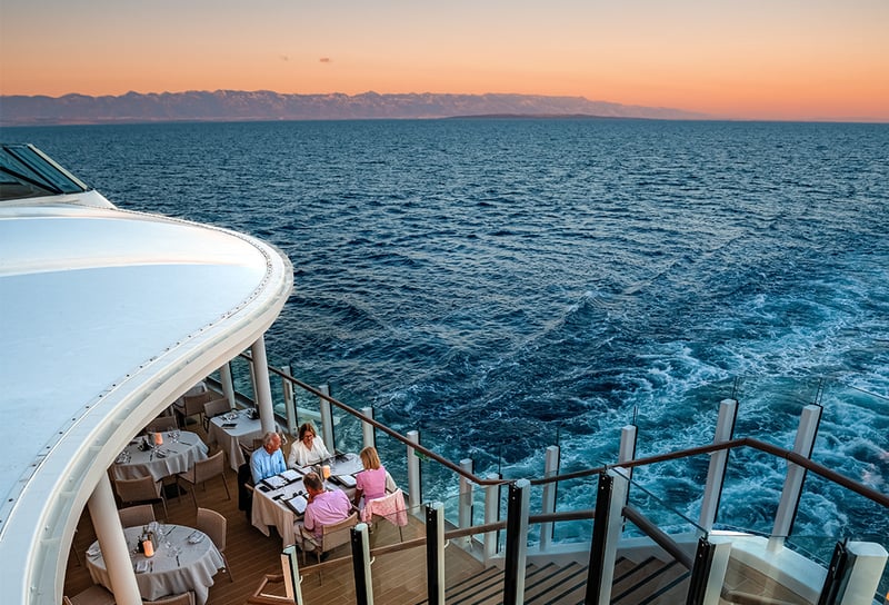 Sunset in the background on Silversea Cruises ship sailing in the Mediterranean in La Terrazza restaurant - Silversea vs Regent Seven Seas Which Luxury Cruise Line