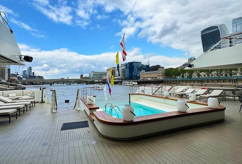 Pool-deck-on-Ponant-Le-Bellot-docked-next-to-HMS-Belfast-with-the-background-of-London-bridge-Ponant-Le-Bellot-Review-A-Ship-Visit-on-the-Thames