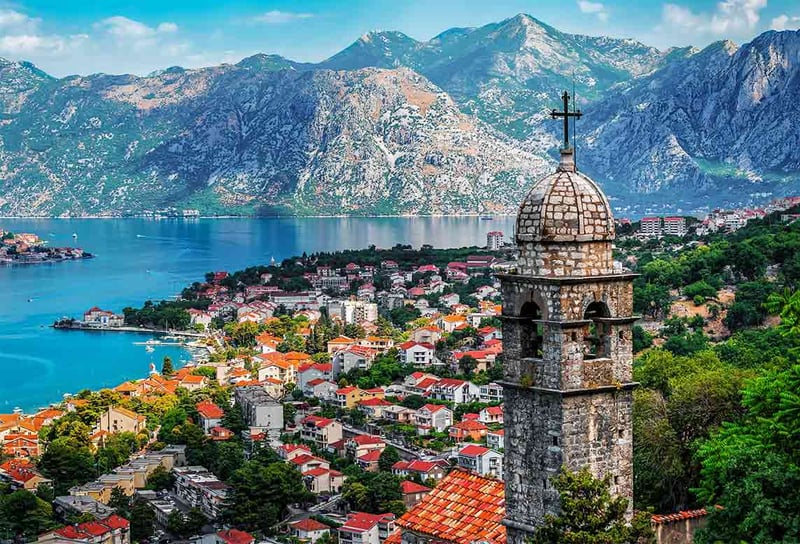 Bell-tower-of-Church-Our-Lady-of-Remedy-on-the-hill-tower-in-the-old-city-of-Kotor-and-the-Kotor-Bay-in-Montenegro-Crystal-Grace-Cruise-Ship-Guide