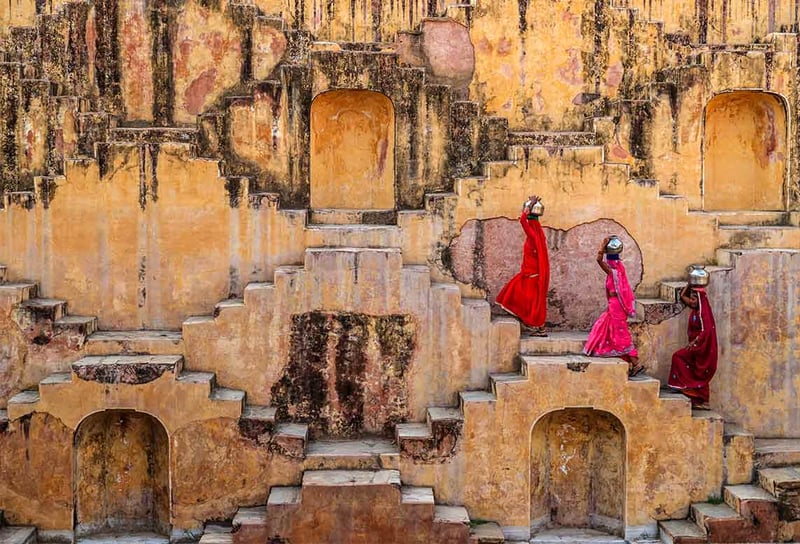 Jaipur-three-ladies-in-sarees-carrying-water-up-stairs-in-India-Scenic-Aura-India-River-Cruising-&-Land-Journeys