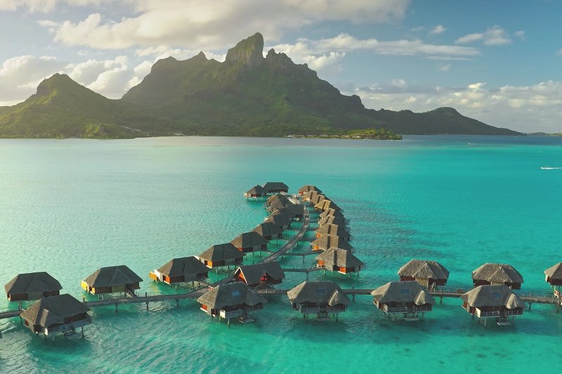 row of water bungalows in french polynesia.