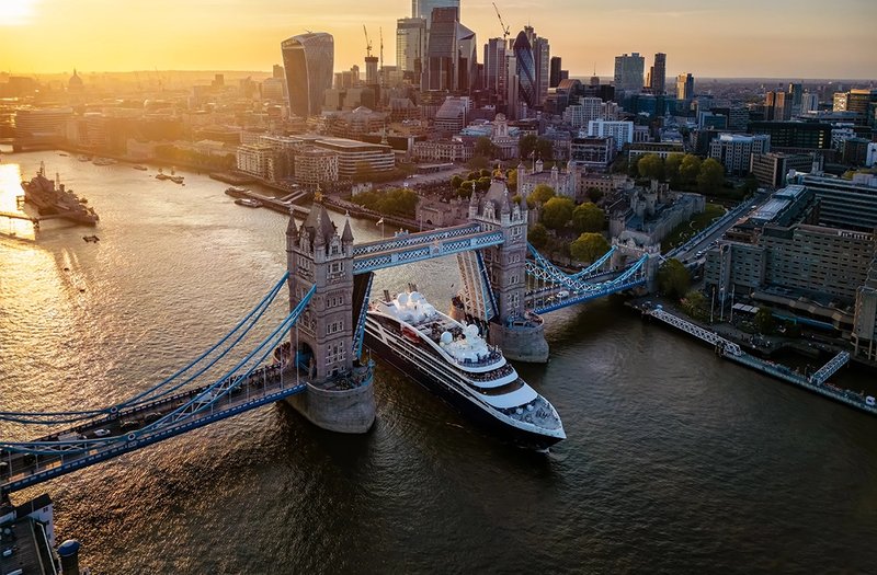 Photo of a Ponant ship sailing under Tower Bridge in London